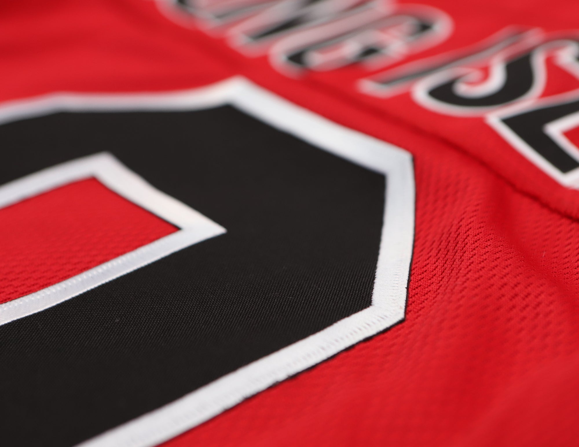 Long Island Ducks 1965-66 Jersey (CUSTOM - PRE-ORDER) in red with black and white stitched vintage hockey number detail close-up