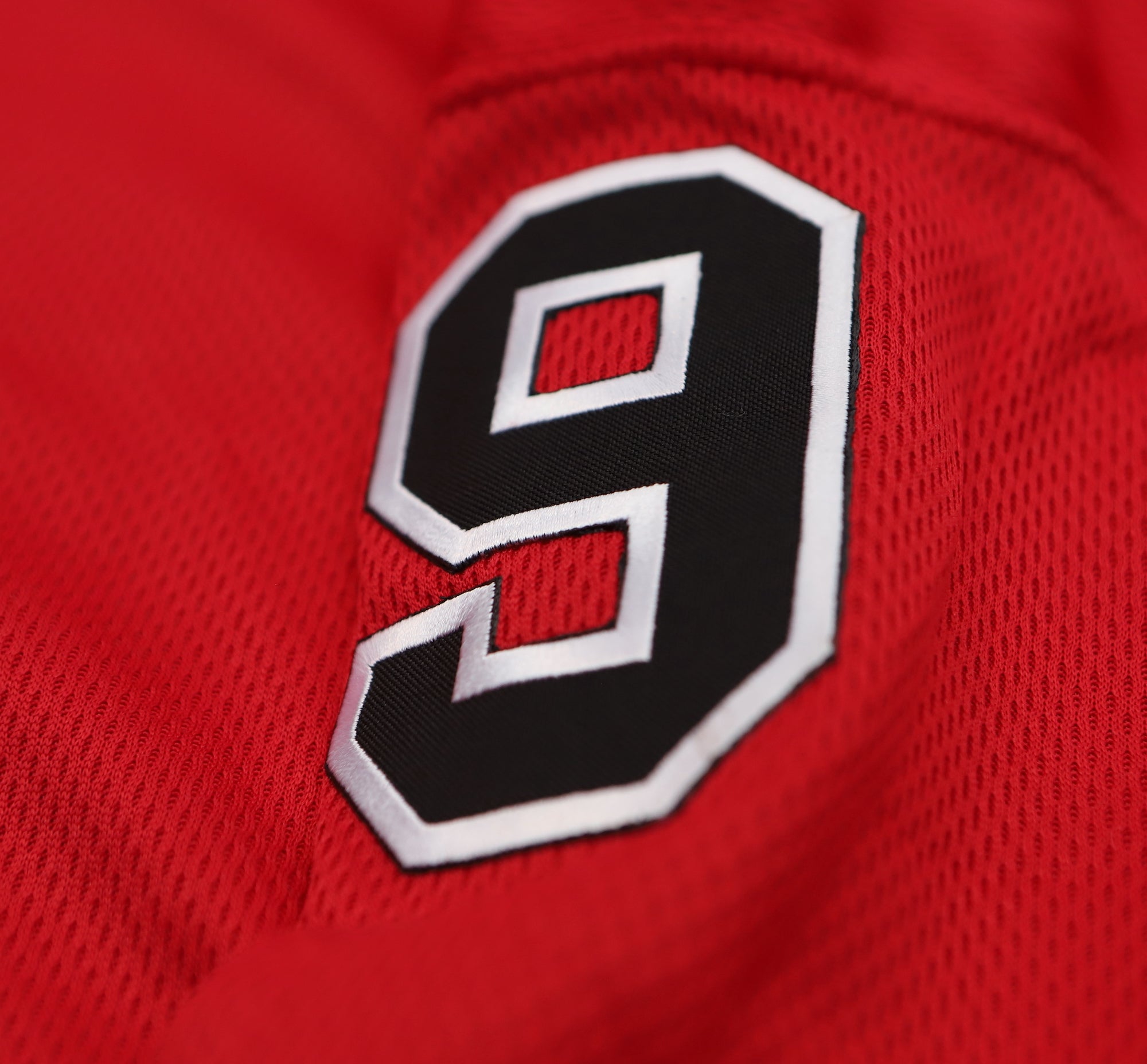 Long Island Ducks 1965-66 Jersey (CUSTOM - PRE-ORDER) close-up of black and white number 9 on red vintage hockey fabric